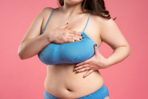 Woman in sports bra with large breasts who may want breast reduction surgery